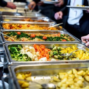 Cuisine Culinary Buffet Dinner Catering Dining Food Celebration Party Concept. Group of people in all you can eat catering buffet food indoor in luxury restaurant with meat and vegetables.