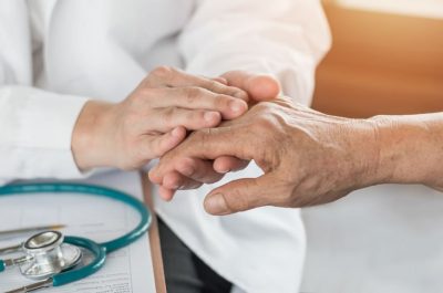 Elderly senior adult patient (older person) having geriatric doctor consulting and diagnostic examining on aging and mental health care in medical clinic office or hospital examination room